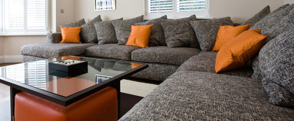A bespoke sectional sofa designed to fit into a large family room, to accommodate a teenage family, friends and dogs.